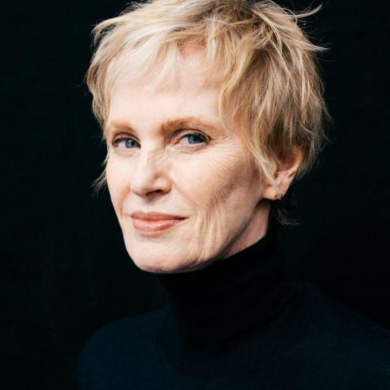 Kvinde i sort tøj med kort hår der ser ind i kammeret